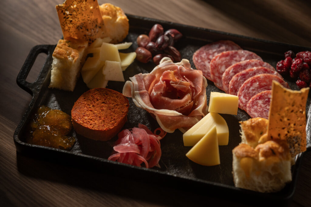 Artisan charcuterie and cheese board with assorted garnishes at Katerina Restaurant
